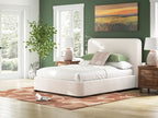 Beige upholstered bed with tall headboard and thick padded mattress frame