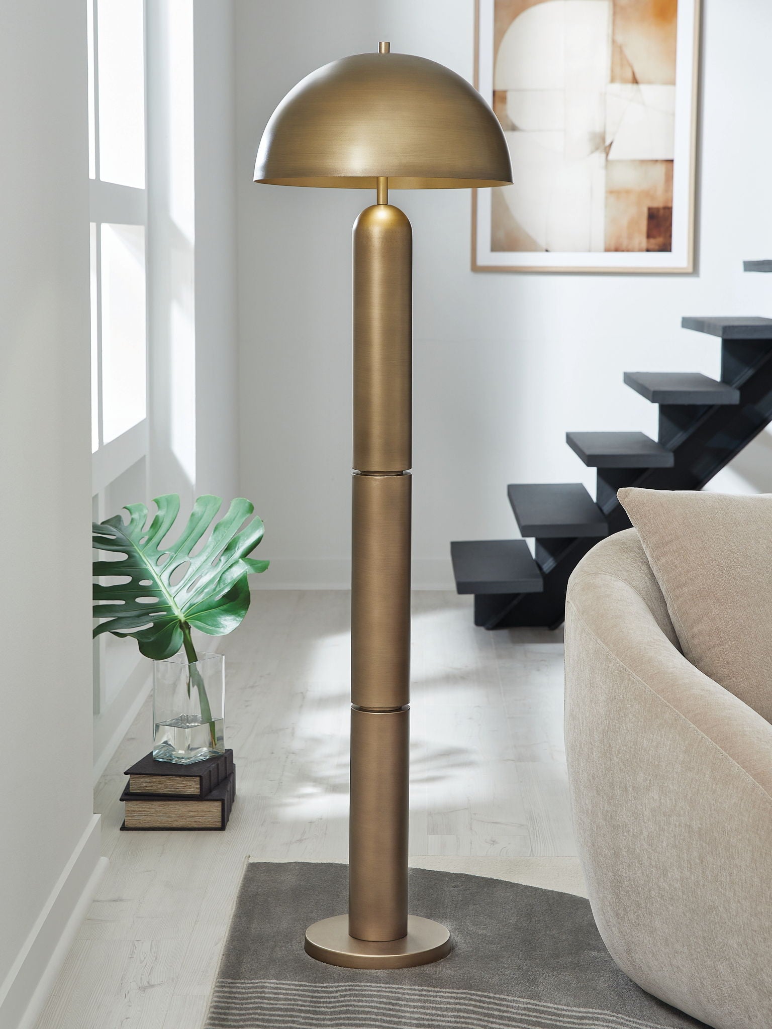 Brass metal floor lamp with domed shade and tall slender base