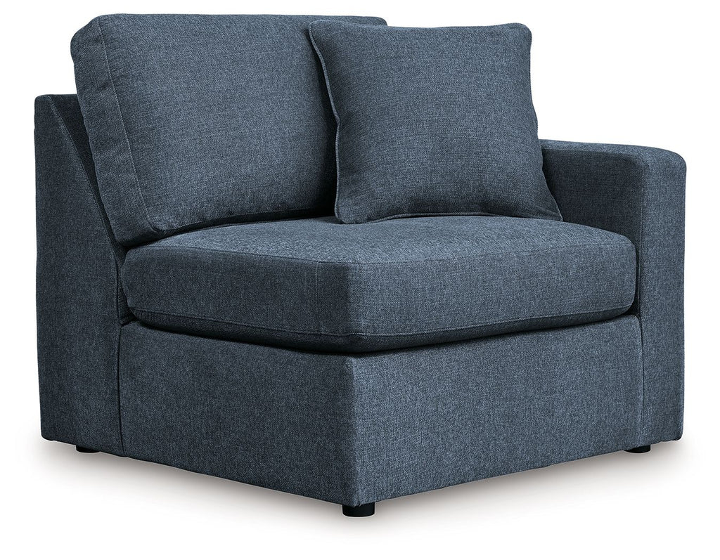 Dark navy upholstered corner chair with chaise-style seat and two back cushions