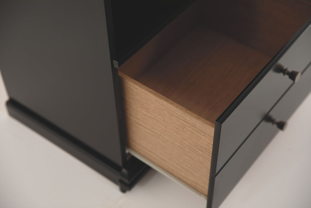 Black nightstand drawer open, light wood interior, round knob, side rails