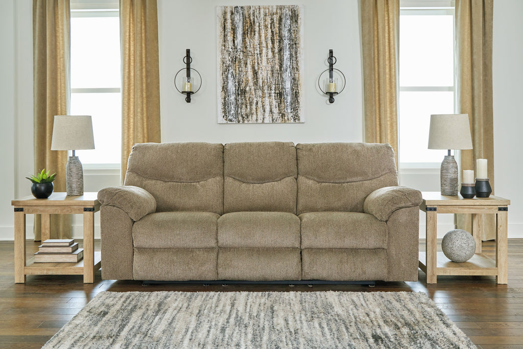 Reclining sofa in beige fabric with three seat sections and rolled armrests, styled in a room.