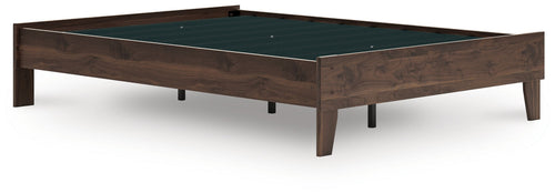Platform bed with light brown wood frame and dark green inset panel