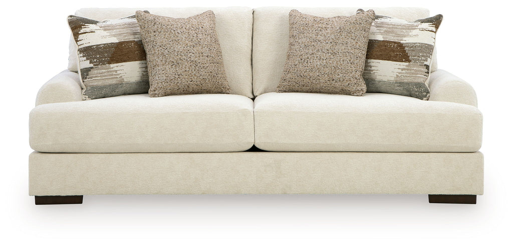 Light beige fabric sofa with three seat cushions and decorative back pillows