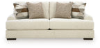 Light beige fabric sofa with three seat cushions and decorative back pillows