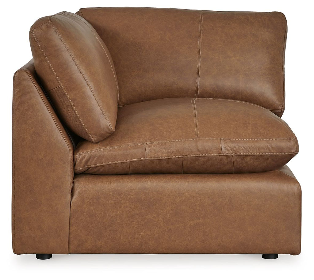 Caramel brown wedge upholstered seating section with deep seat, rounded back, stitched seams