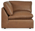 Caramel brown wedge upholstered seating section with deep seat, rounded back, stitched seams