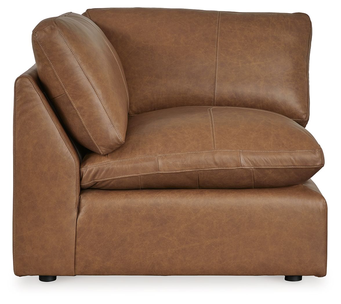 Caramel brown wedge upholstered seating section with deep seat, rounded back, stitched seams