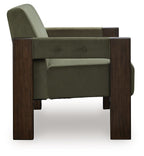 Green accent chair with dark wood arms and button-tufted back panel