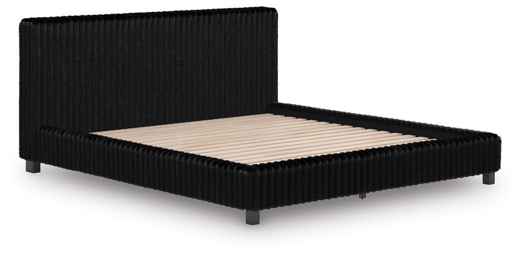 Black upholstered platform bed with tall headboard and beige mattress insert.