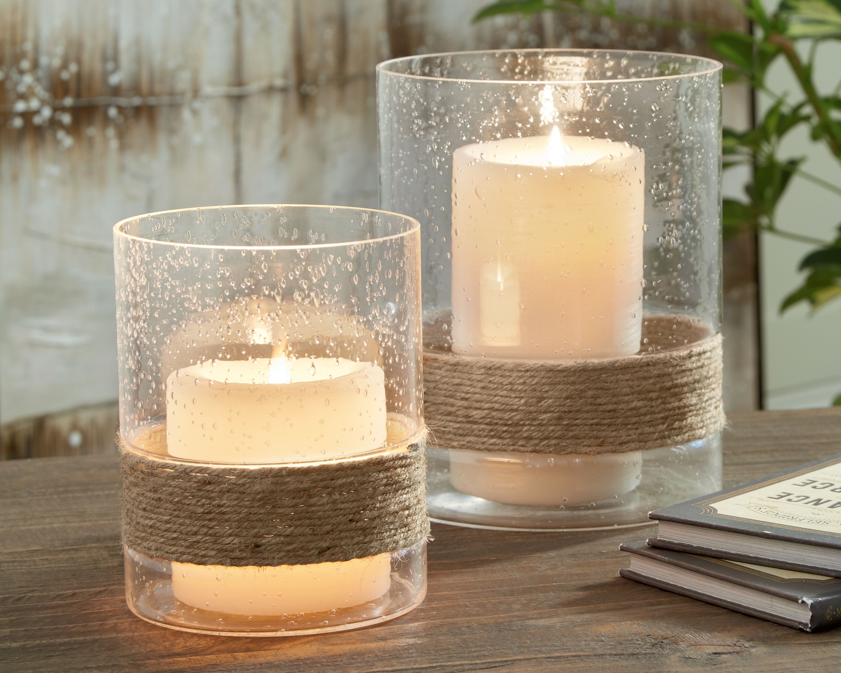 Set of 2 clear glass votive candle holders with jute band and lit candles