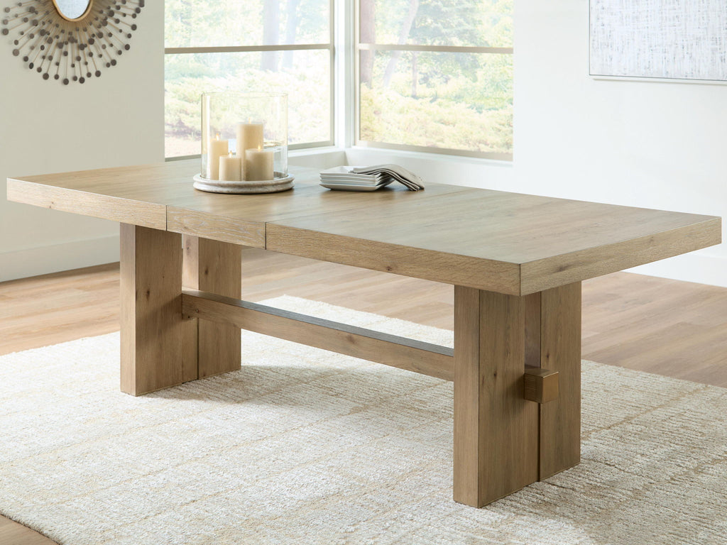 Light brown rectangular dining table with extension leaf and thick square legs