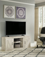 Light beige wood TV console with two doors and center shelf, holding TV and media