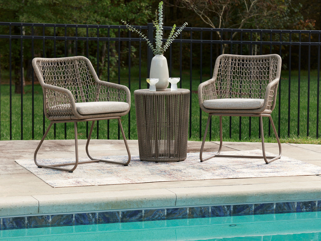 Outdoor patio set with two beige mesh chairs and round beige table centerpiece.