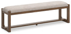 Upholstered dining bench with oatmeal fabric seat and light brown wooden base, side view