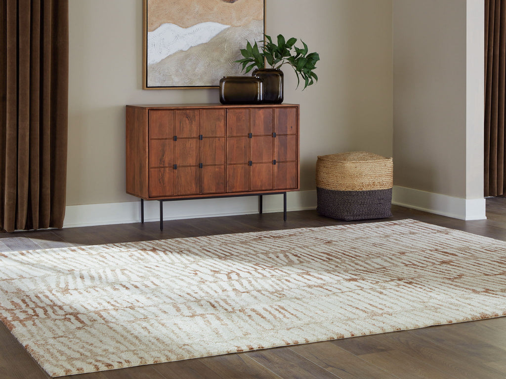 Area rug with cream and rust abstract pattern, laid out on the floor