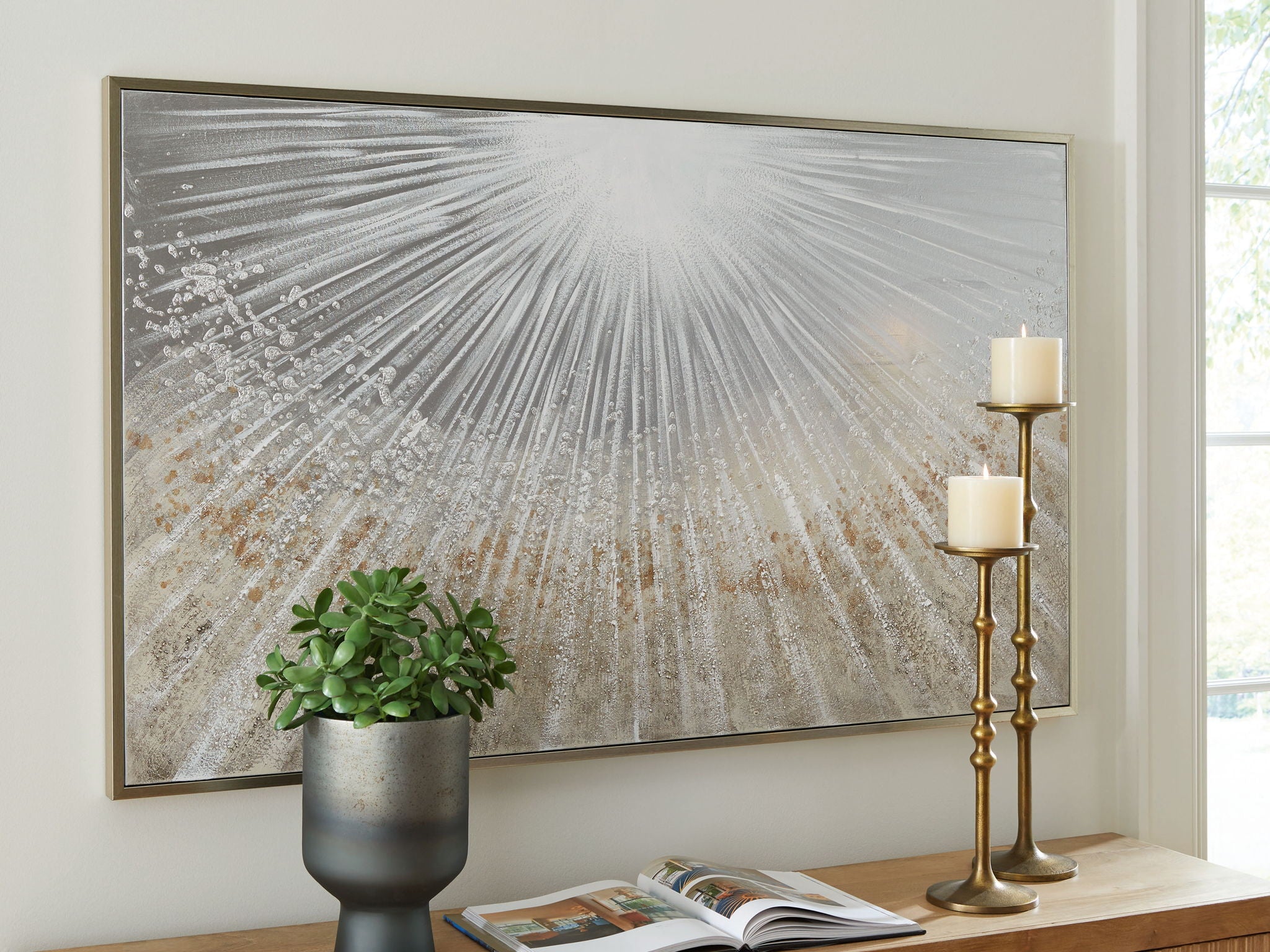 Framed wall art with radiating gray, taupe, and white paint pattern in horizontal frame