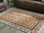 Rectangular brown area rug with repeating medallions and ornate border, flat weave.