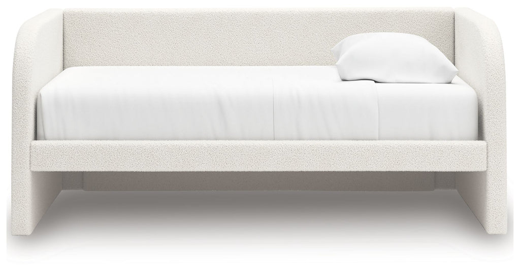 White upholstered day bed with padded headboard and two throw pillows