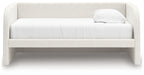 White upholstered day bed with padded headboard and two throw pillows