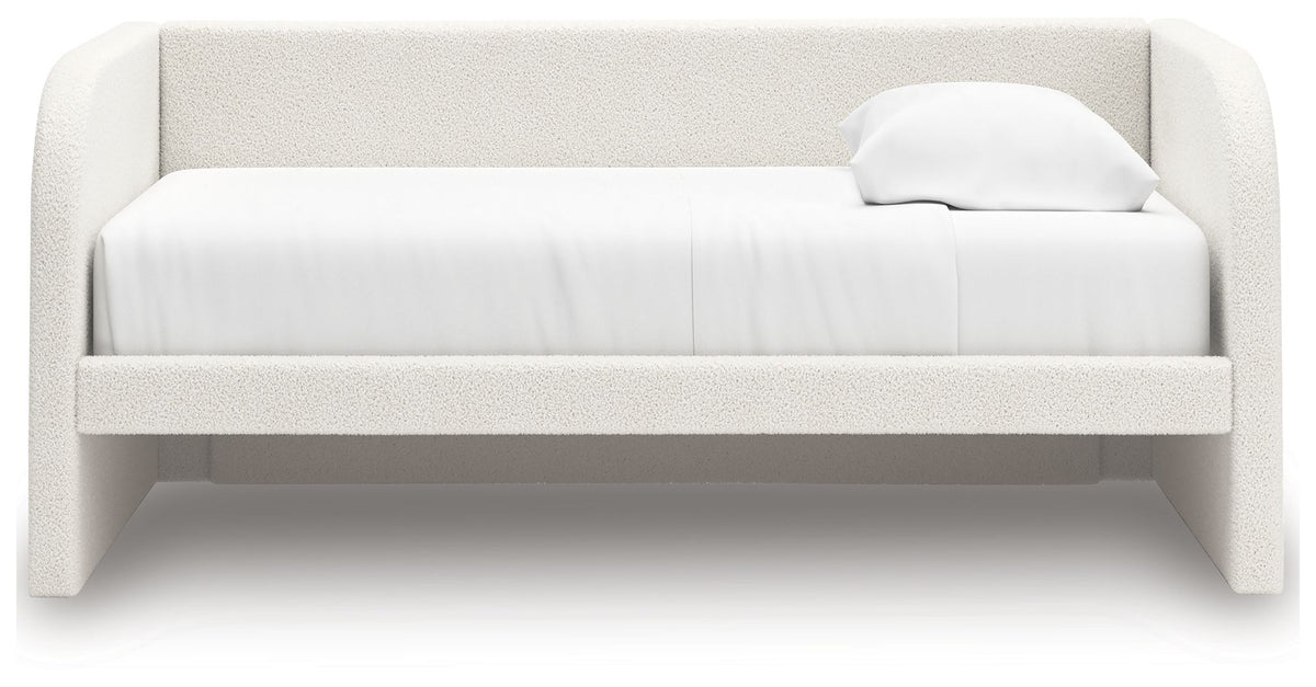 White upholstered day bed with padded headboard and two throw pillows