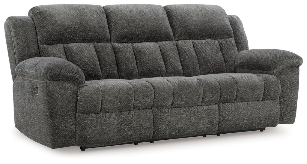 Reclining sofa in dark gray fabric with padded headrest and smooth reclining seat