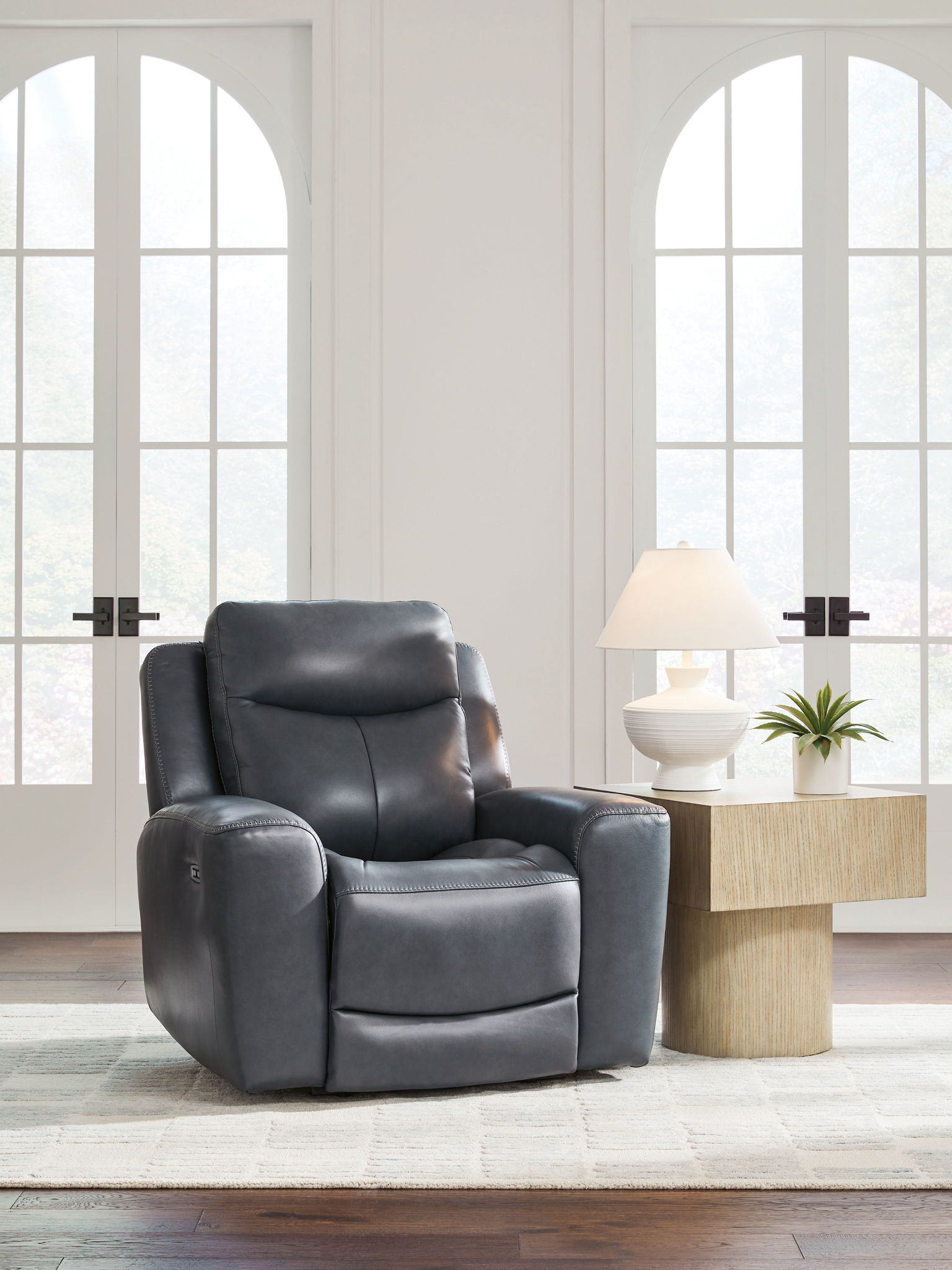 Blue leather-look power recliner with adjustable headrest and reclined seating
