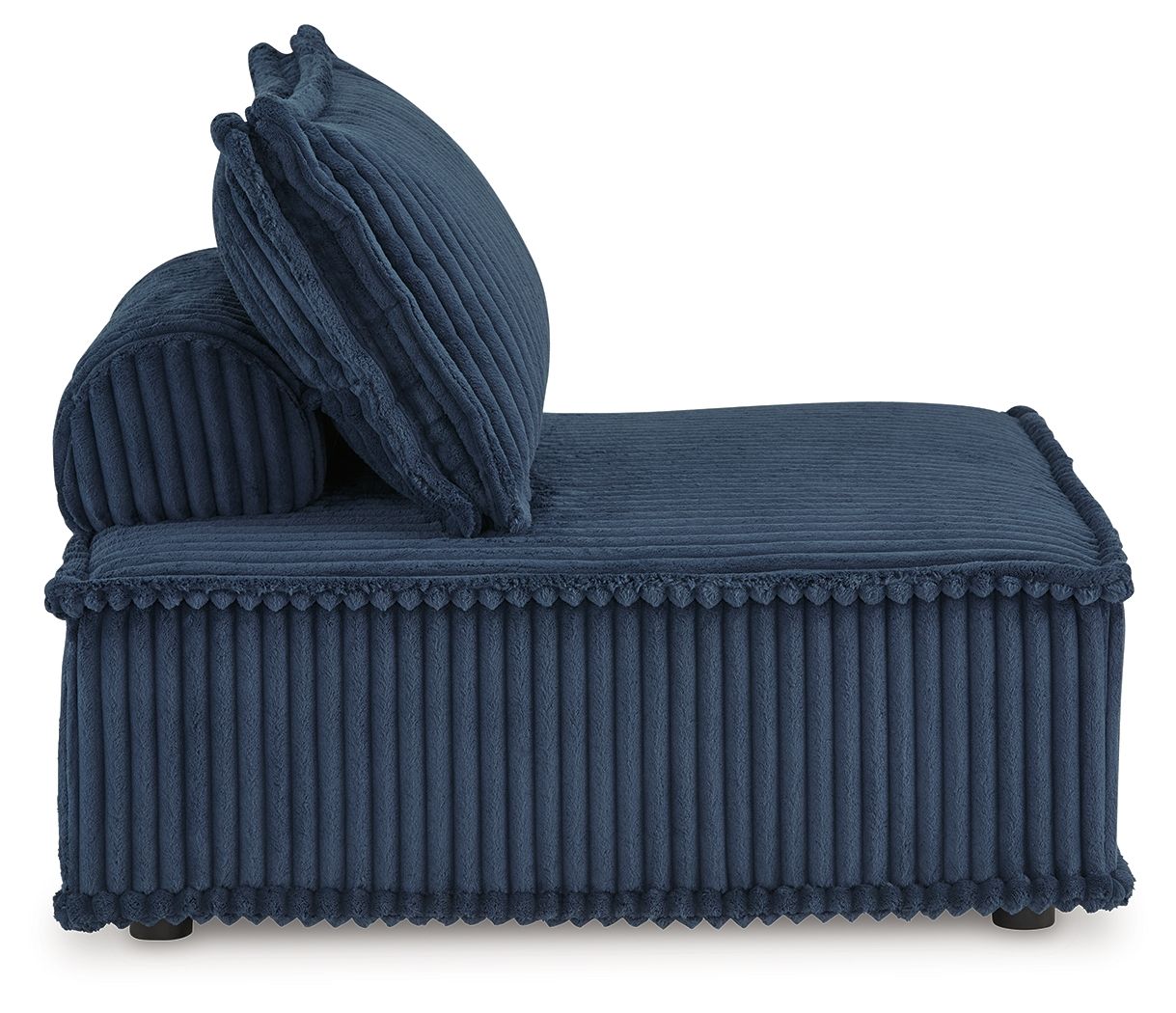 Blue ribbed accent chair with attached back cushion and curled throw pillow