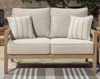 Beige loveseat with two striped throw pillows and two back cushions, driftwood frame