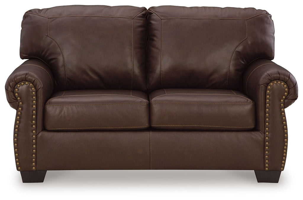 Dark brown loveseat front view with tufted cushions and nailhead trim