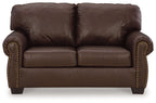 Dark brown loveseat front view with tufted cushions and nailhead trim