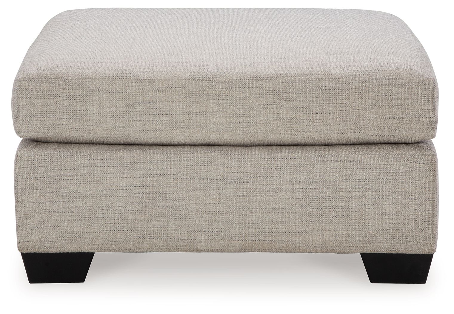 Oversized ottoman with light beige fabric, thick cushioned seat and squared black legs.