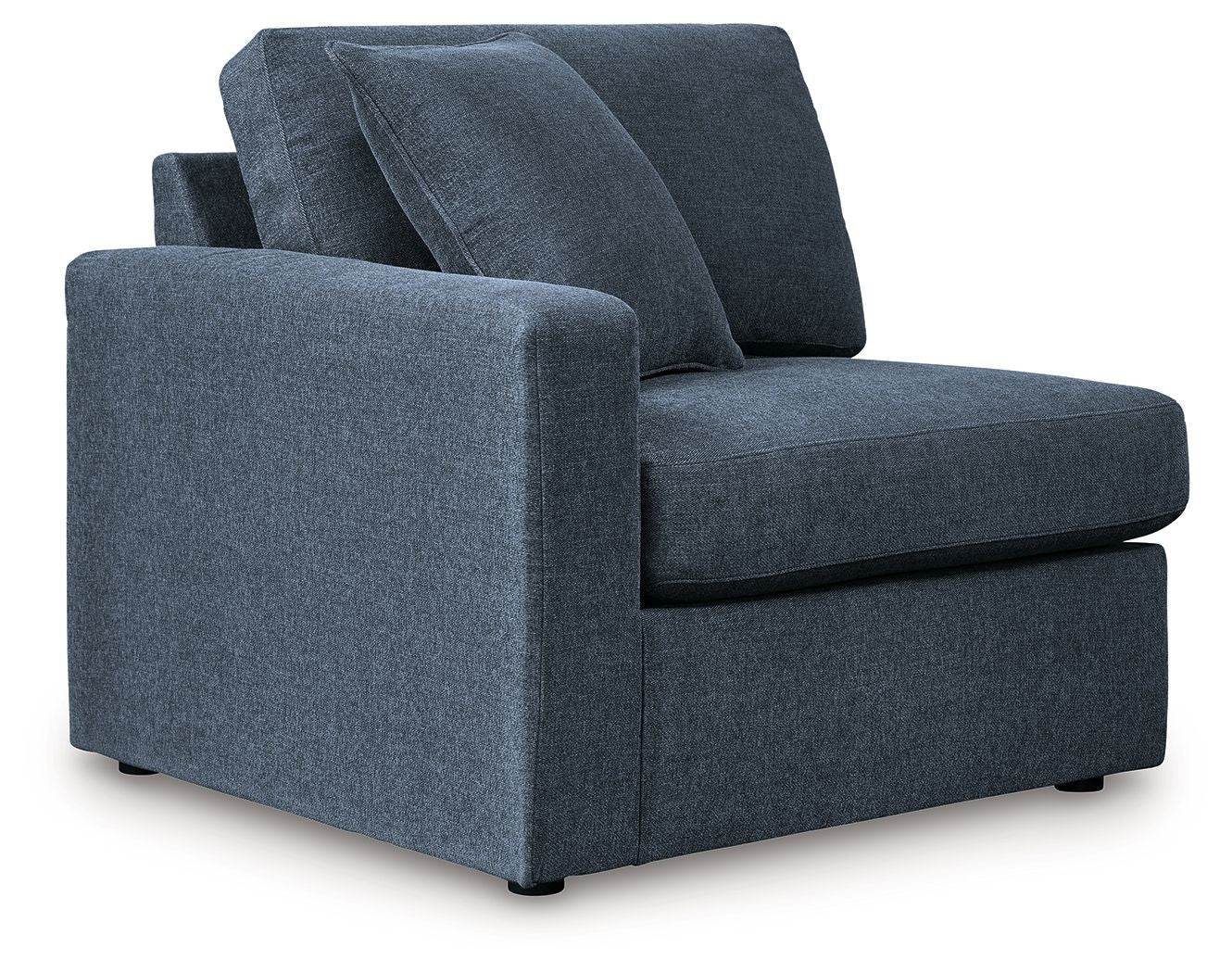 Ink blue fabric corner chair with wide armrests and deep, tufted seat cushions.