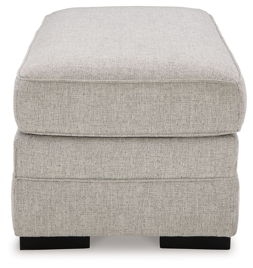 Light gray upholstered ottoman top with thick cushion and black block feet