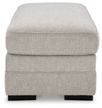 Light gray upholstered ottoman top with thick cushion and black block feet
