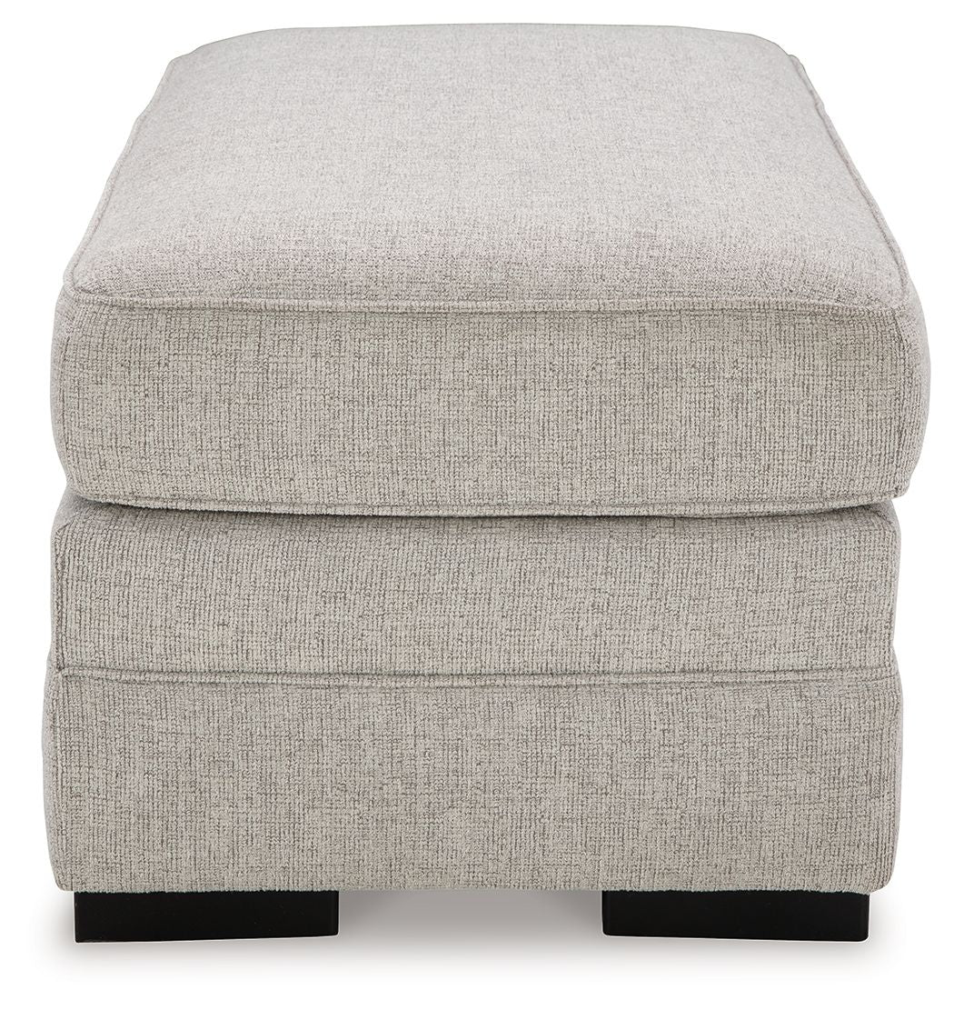 Light gray upholstered ottoman top with thick cushion and black block feet