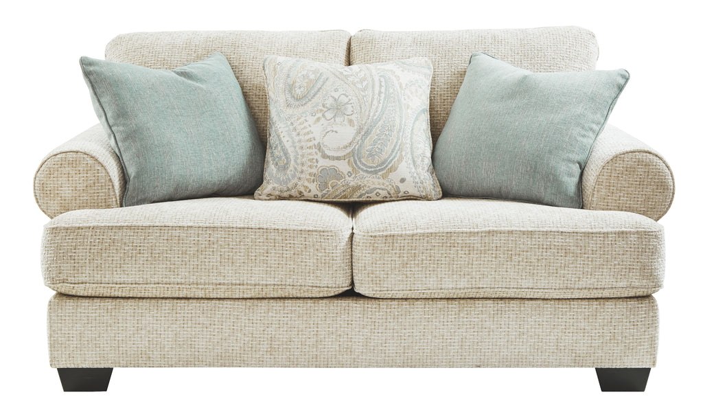 Sandstone loveseat front view with two teal pillows and a light patterned throw pillow