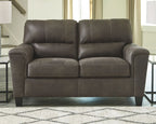 Dark gray recliner sofa with tufted seat and back cushions