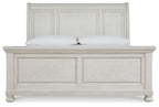 White sleigh bed with paneled headboard, matching footboard, and turned feet.