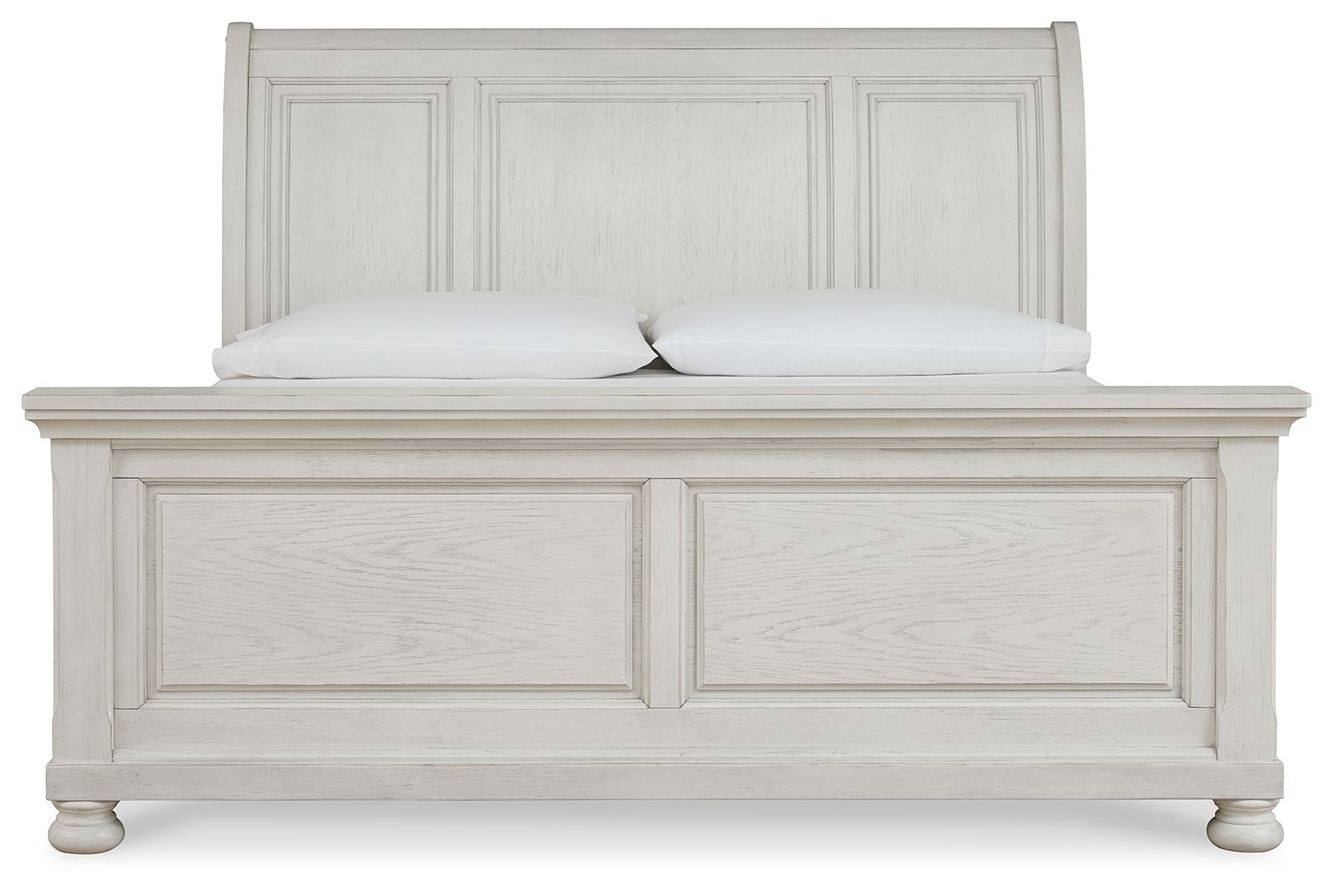 White sleigh bed with paneled headboard, matching footboard, and turned feet.