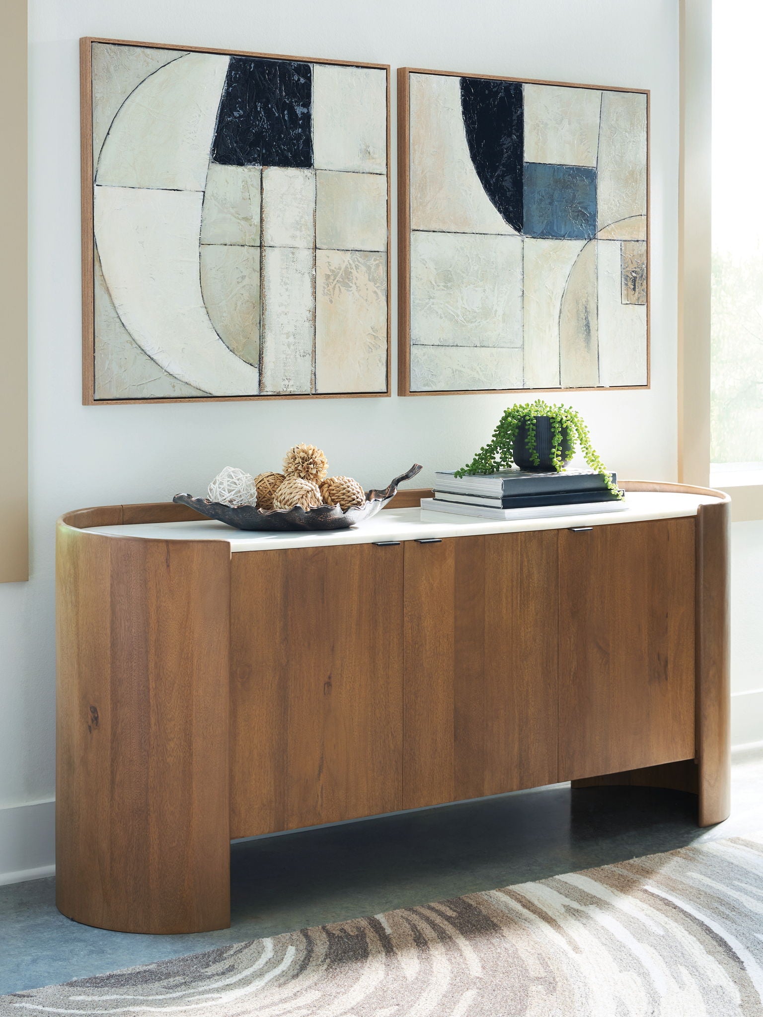 Brown wood accent cabinet with white tabletop and curved panel doors
