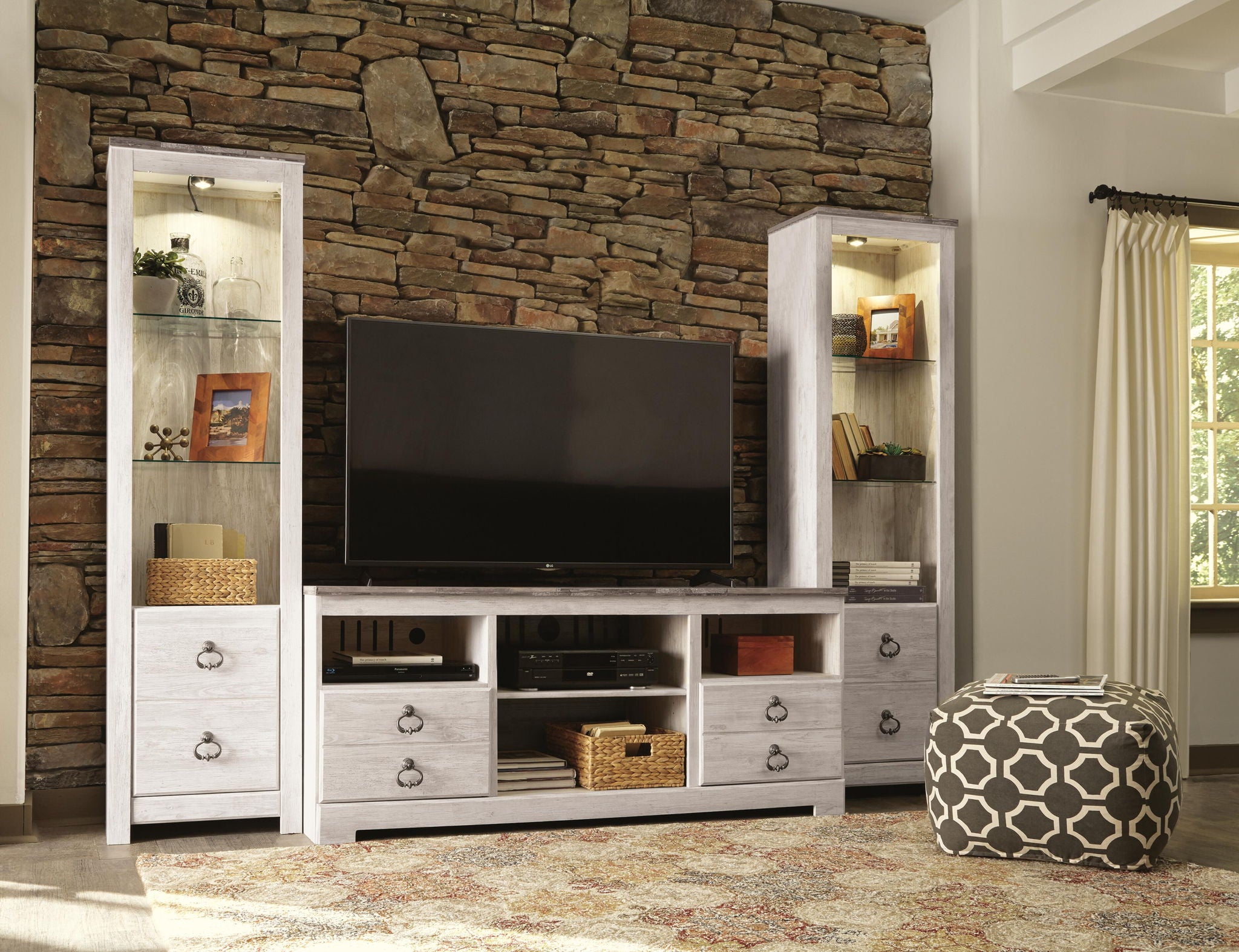 Beige entertainment center with TV stand, open shelves, and glass display cabinets with drawers