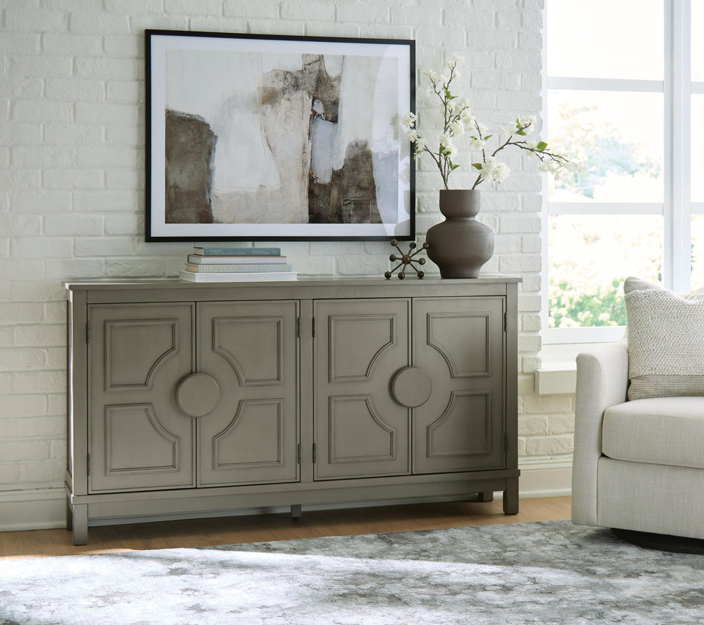 Warm gray accent cabinet with four paneled doors and circular knob hardware, legs