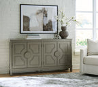 Warm gray accent cabinet with four paneled doors and circular knob hardware, legs