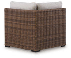 Dolan Creek outdoor corner with cushion, beige cushions on brown woven wicker chair
