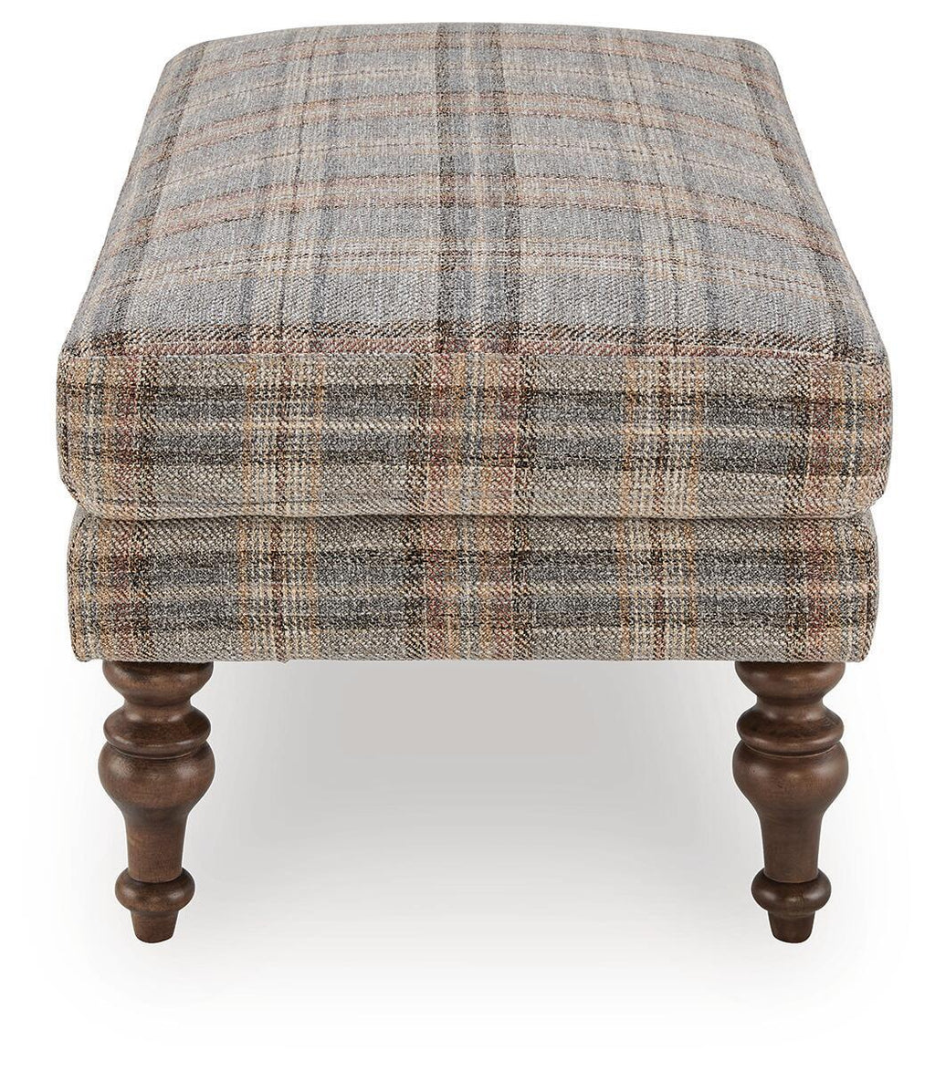 Multi plaid upholstered ottoman with squared sides and dark turned wooden legs