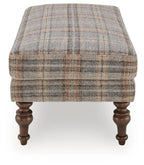 Multi plaid upholstered ottoman with squared sides and dark turned wooden legs
