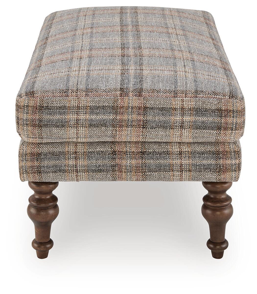 Multi plaid upholstered ottoman with squared sides and dark turned wooden legs