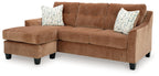 Brown sectional sofa with chaise and two patterned accent pillows, black legs