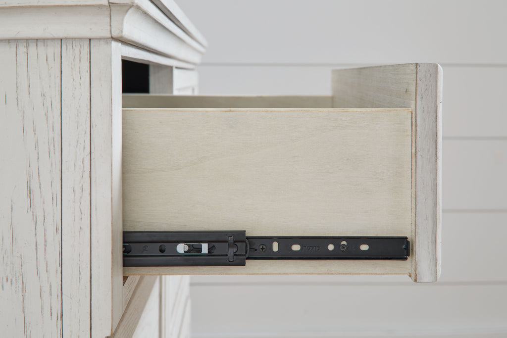 Antique white dresser open drawer showing black hardware track and metal brackets