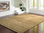 Light brown rug with geometric block pattern and stitched detailing along border